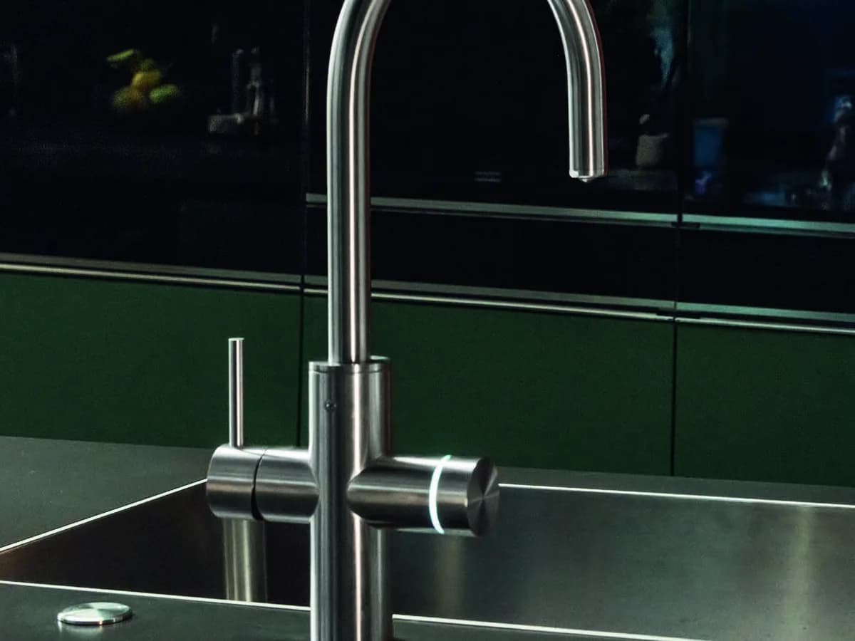 Franke Mythos Water Hub 5-in-1 tap in stainless steel at a steel sink, with the LED control ring lit